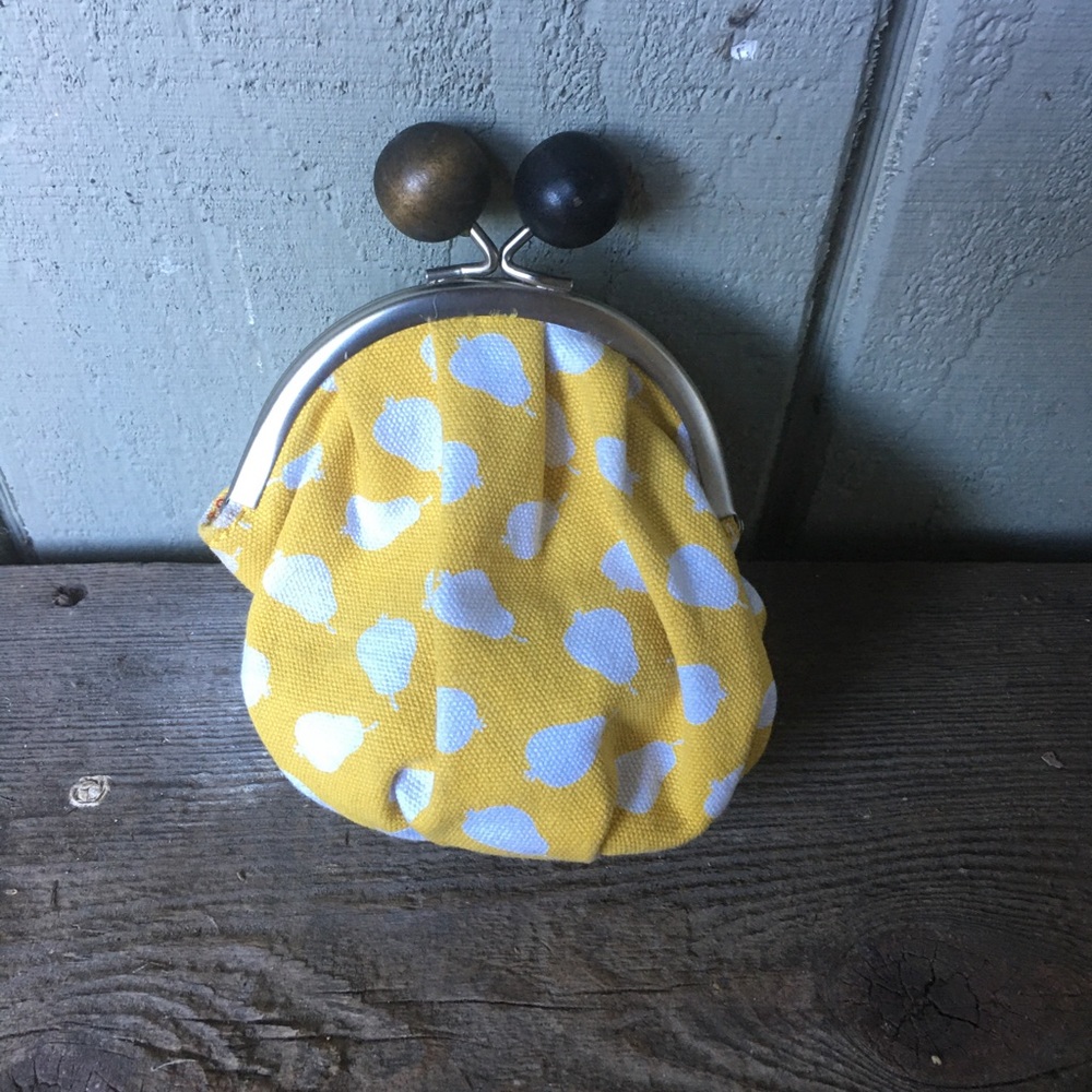 Yellow with little white splotches, coin purse.